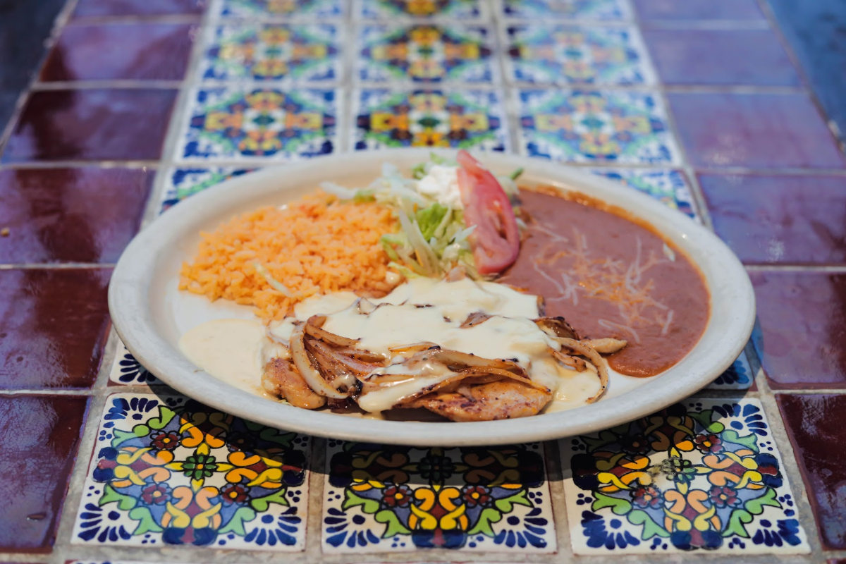 Grilled meat with sauce, rice and salad
